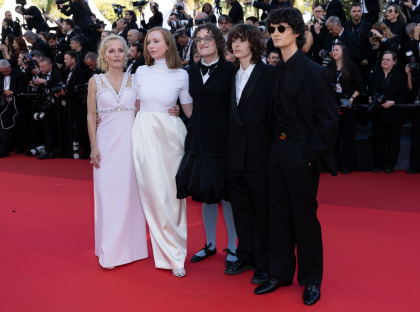 Gillian Anderson wore big, bouncy curls & two Miu Miu looks in Cannes